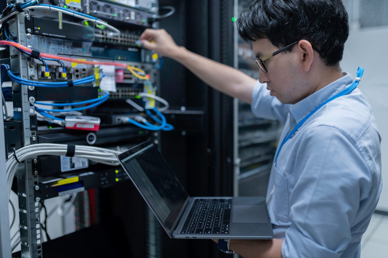 IT Technician working in a comms cab